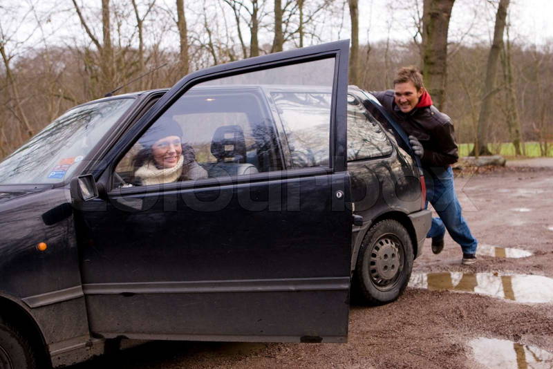 986657-32643-man-pushing-a-car-on-a-muddy-field.jpg